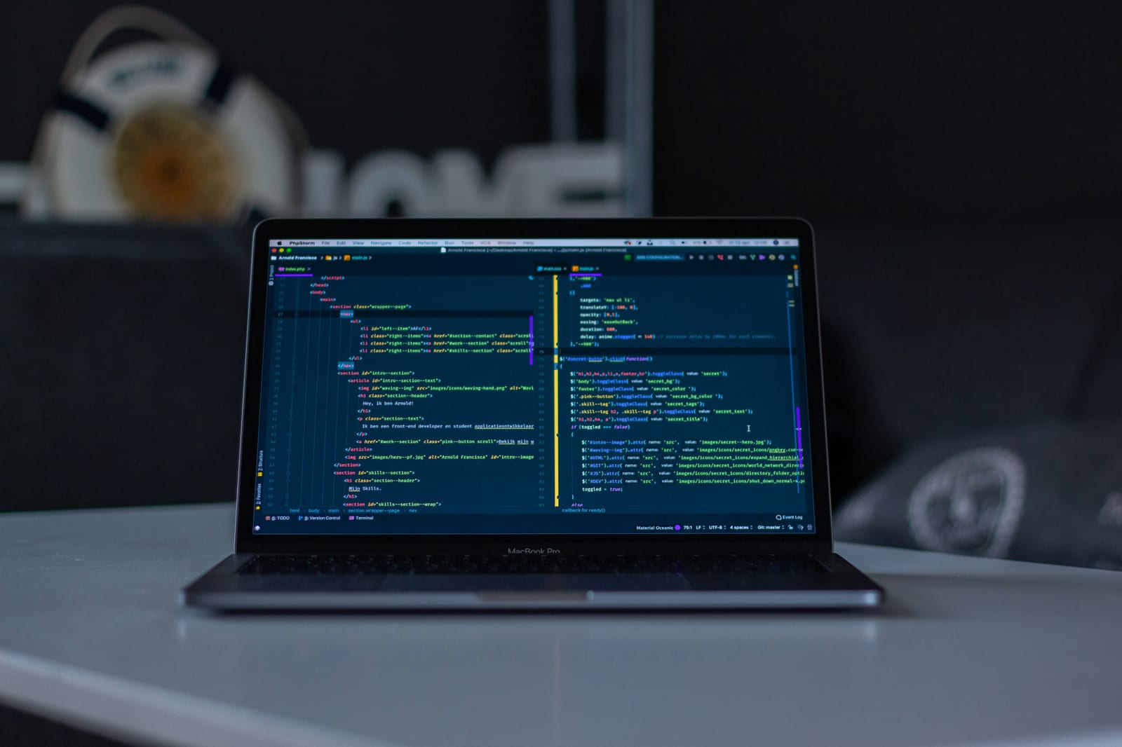 A laptop open on a desk with code in an editor.